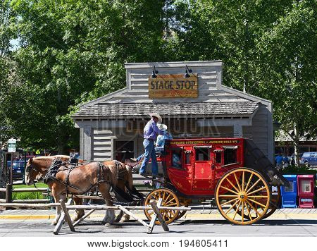 JACKSON HOLE, WYOMING - JUNE 27, 2017: Town Square Stagecoach Ride. Visitors can enjoy a leisurely Stagecoach Ride and tour of historic Jackson Hole.