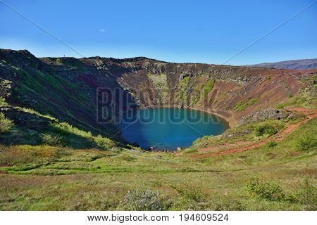 View into the Kerid crater with its blue lake at the bottom as a part of the famous Golden Circle in western Iceland