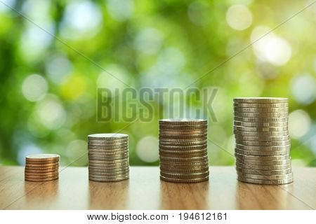 money stacks are arranged from small coins to big coins that mean growing of money with nature bokeh background for feel relaxconcept simply and happy investment.