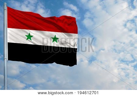 National flag of Syria on a flagpole in front of blue sky.