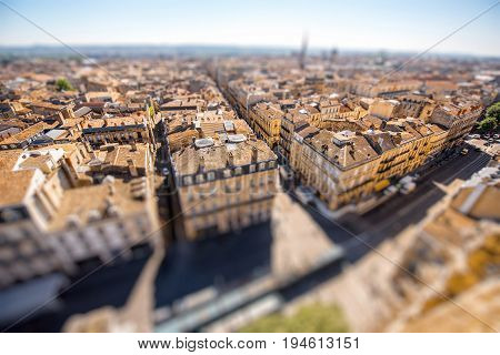 Aerial cityscape view on the old town of Bordeaux city during the sunny day in France. Tilt-shift image technic