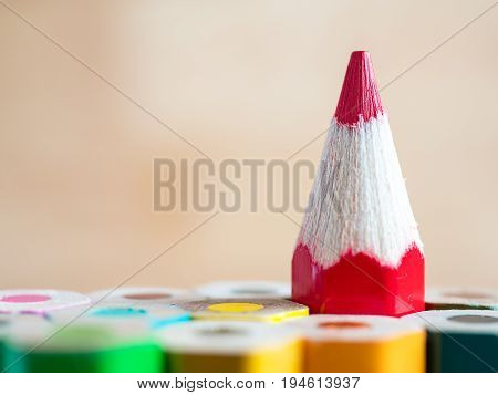 Red color pencil stand on various color pencil with wood blur background (Leadership concept)