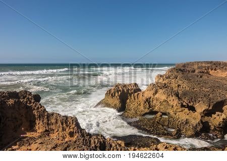 Waves  Breaking Of Cliffs Near Oualidia Lagoon In Same Name Village In Atlantic Ocean Coast, Morocco