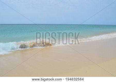 Perfectly clear beach and sky with crashing waves