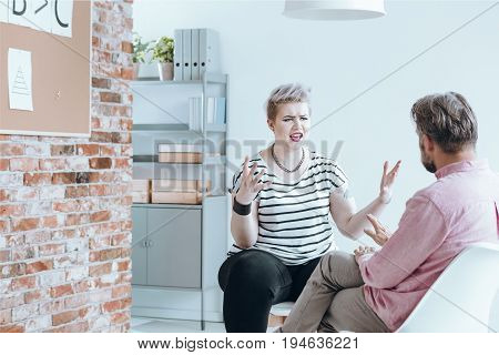 Rebellious girl bursting with anger at her therapist