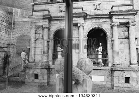 Young, Beautiful Bride And Groom Walking Along The Street In The City