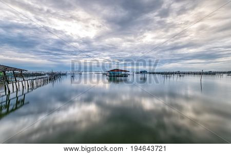 Homestay and floating basket in lake at Kohyo Songkhla Thailand with beautiful sky and clouds. This is traditional fisheries area.