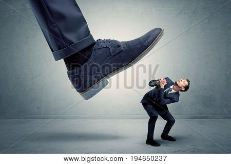 Demoralised employee symbolized by small man getting trampled