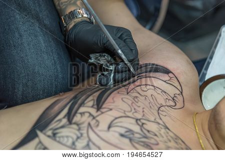 Tattoo Artist Drawing Art On Body