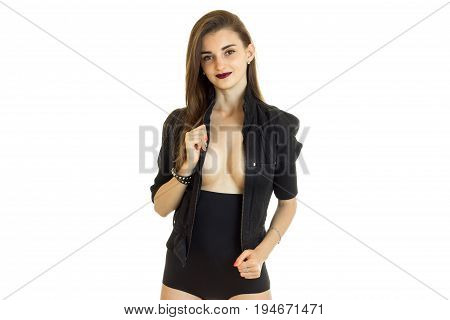 cheerful brunette woman in black jacket and panties with big silicon breasts isolated on white background