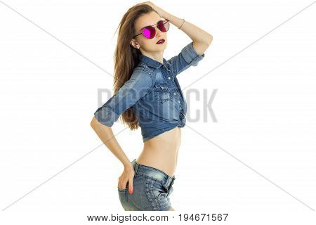 cute young bruntte in denim clothes and sunglasses isolated on white background
