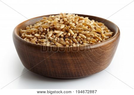 Kamut Wheat Kernels In Dark Wooden Bowl Isolated On White.