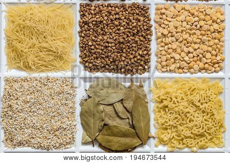 Grocery set of food products: vermicelli buckwheat dried peas barley grits bay leafs figured macaroni.