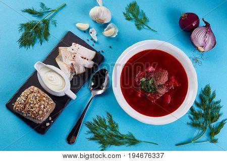 ukrainian soup borsch on blue color background. Traditional ukrainian dish borsch isolated on white table, top view. first course