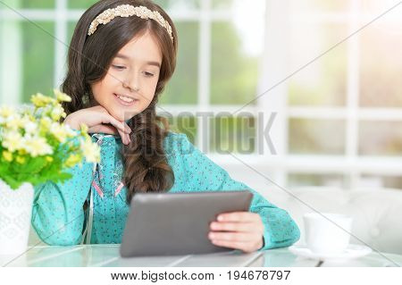 Portrait of  Beautiful little girl with tablet pc