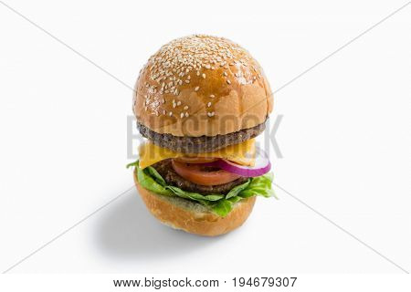 High anlge view of hamburger with vegetables and cheese against white background