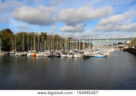 Alignment of sailboats in Port-Rhu harbor and bridge in Douarnenez