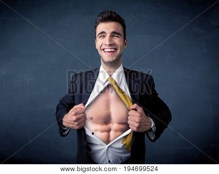 Businessman tearing off his shirt and showing mucular body concept on background