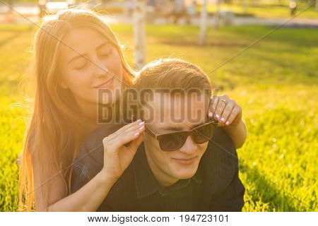 Beautiful young happy couple having fun in the grass