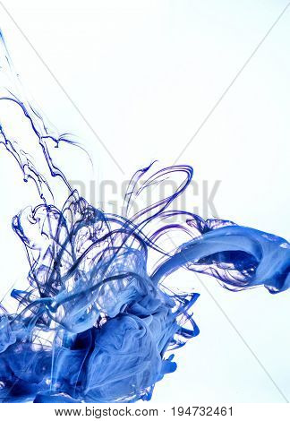 Ink swirl in a water on white background. The paint in the water. Soft dissemination a droplets of colored ink in water close-up. Explosion of color splashes acrylic ink.