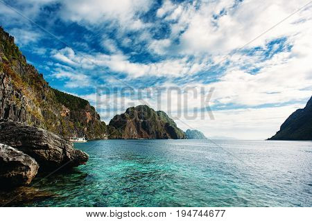 El Nido Palawan Philippines. Sharp rocks in lagoon. Blue sky with clouds and clear sea water.