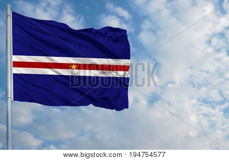 National flag of Cape verde on a flagpole in front of blue sky.