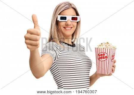 Young woman with 3D glasses and popcorn making a thumb up gesture isolated on white background