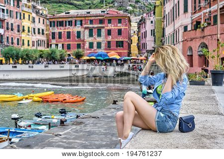 Tourist Girl in Vernazza Cinque terre Italian riviera. Sea and mountain view. Cinqueterre Liguria beauty