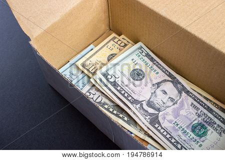 A pile of dollar bills lying in a box.