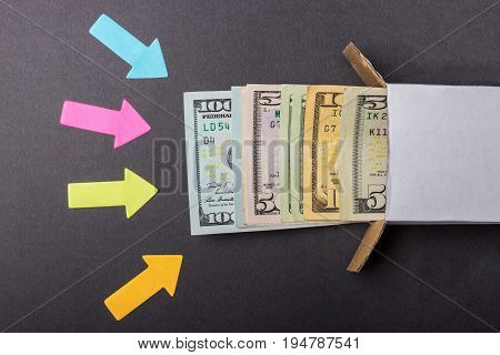 Arrows point to a stack of dollar bills looking out of the box. Increase in savings. Home safe. Business concept.