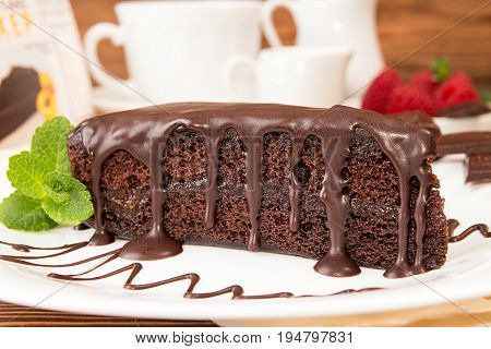 Sachertorte. Piece Of Sacher Cake On White Plate Garnish With Mint And Raspberry.