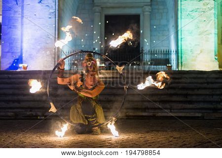 Elvas Portugal - july 1 2017. Female fire show performer at night participing in festival medieval in Elvas