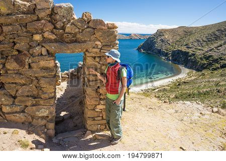 Tourist Exploring The Ancient Mysterious Inca Labyrinth-like Settlement, Called Chinkana, On The Isl