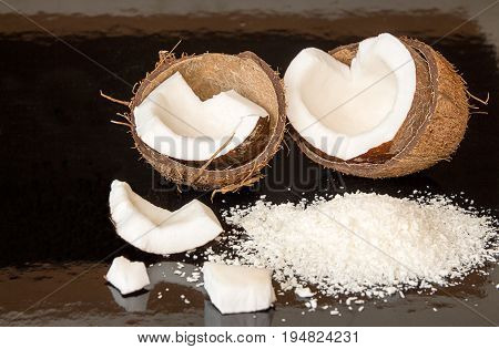 Halfs Of Coconut, Pieces Of Coconat, Coconut Flakes On Black Background.