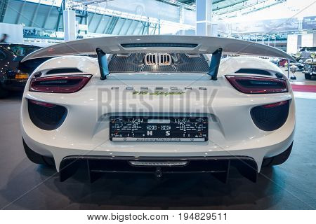 STUTTGART GERMANY - MARCH 17 2016: Mid-engined plug-in hybrid sports car Porsche 918 Spyder 2015. Rear view. Europe's greatest classic car exhibition 