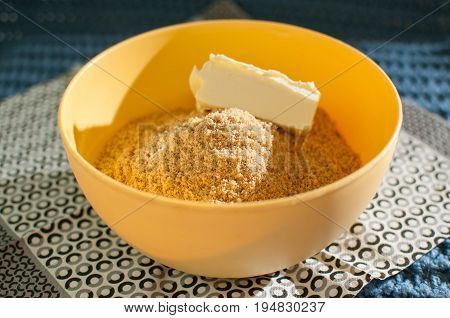 Biscuit Crumbs And Butter In Yellow Bowl Close Up