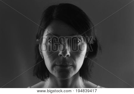portrait of serious woman on grey background