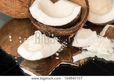 Halfs Of Coconut, Pieces Of Coconat, Coconut Flakes On Black Background.