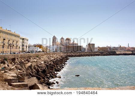 Buildings and Rocks Along the Beach in Cadiz, Spain