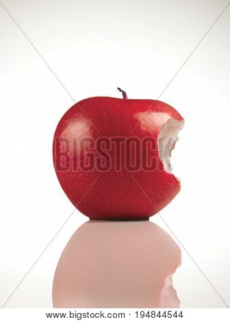 A Single Red Apple with a Bite