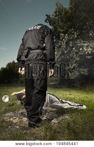 Vagabond young man sleeping in park checked by police patrol