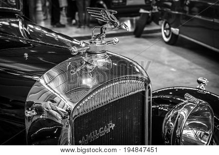 STUTTGART GERMANY - MARCH 18 2016: Hood ornament of vintage car Amilcar M3 1932. Black and white. Europe's greatest classic car exhibition 