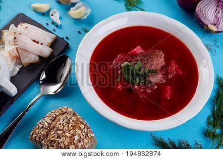 ukrainian soup borsch on blue color background. Traditional ukrainian dish borsch isolated on white table. first course