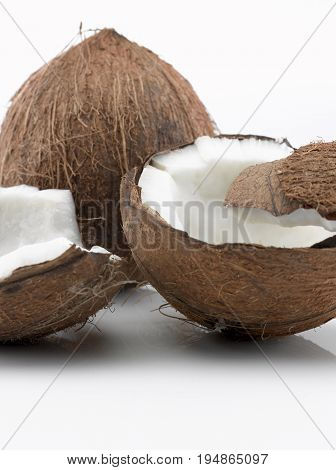 A Coconut cut in Three Pieces and a Whole Coconut