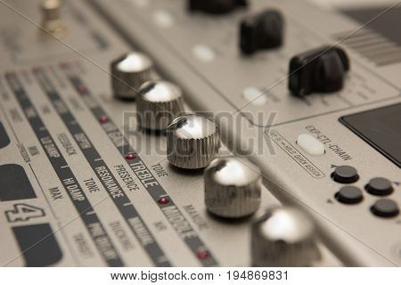 Details of Guitar Music Recording Equipment with Chrome Knobs.