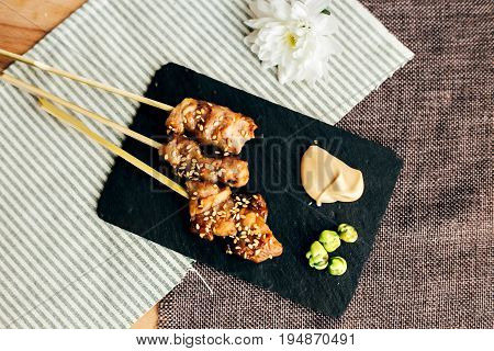 Amazingly tasty and mouth watering sticks tapas of teriyaki chicken as yakitori traditional japanese snack