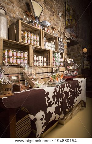 Valognes Normandy France - February 06 2014. Traditional typical delicatessen shop in Normandy. Shop of jams chutney alcohol biscuits pasta beer milk jam and retro products for decoration In wooden boxes