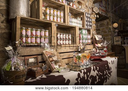 Valognes Normandy France - February 06 2014. Traditional typical delicatessen shop in Normandy. Shop of jams chutney alcohol biscuits pasta beer milk jam and retro products for decoration In wooden boxes