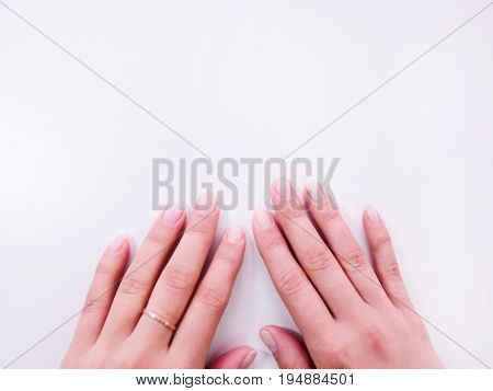 Female hand with ideal manicure top view. Neat hands with perfect nails on white background