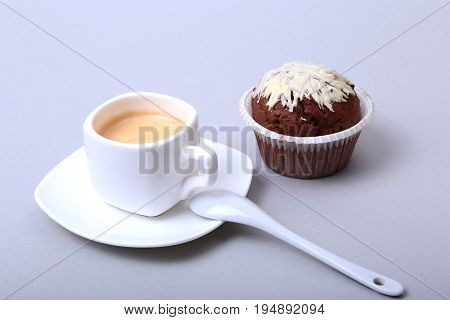 Classic espresso in white cup with homemade cake and chocolate on white background